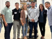 Nataline Lomedico, CEO and president, poses with a group of students from Fresno State's construction management program.